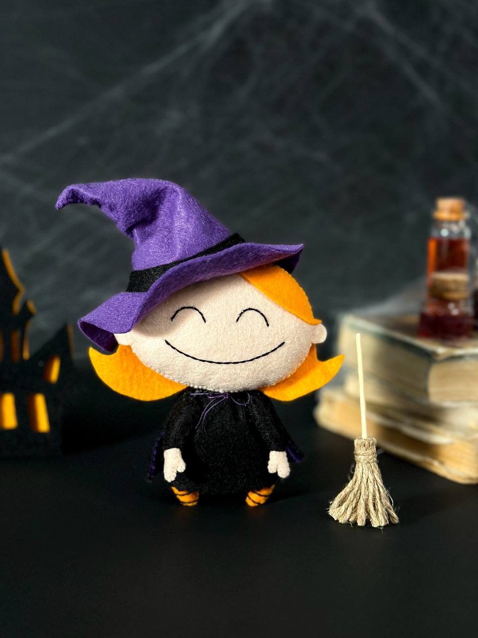 Halloween witch decoration with broom and hat