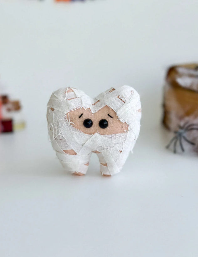 Felt Halloween mummy tooth ornament on white background