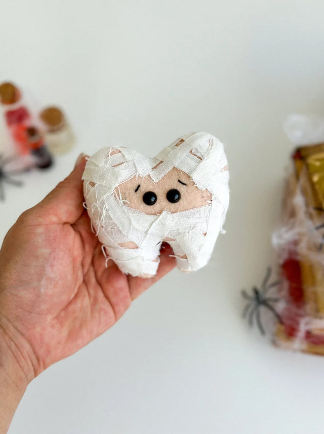 Mummy tooth soft toy in hand for size reference