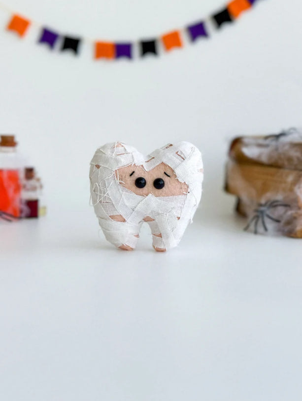 Felt Halloween mummy tooth ornament on white background