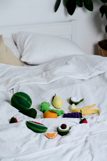 Felt watermelon, avocado, and banana – close-up of colorful felt fruit toys

